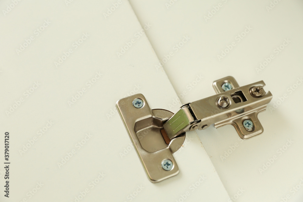 furniture hinge is on white door close up furniture hinge is on white door close up