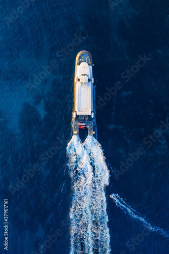 Aerial view on fast boat on blue Mediterranean sea at sunny day. Fast ship on the sea surface. Seascape from the drone. Seascape from air. Travel - image © biletskiyevgeniy.com