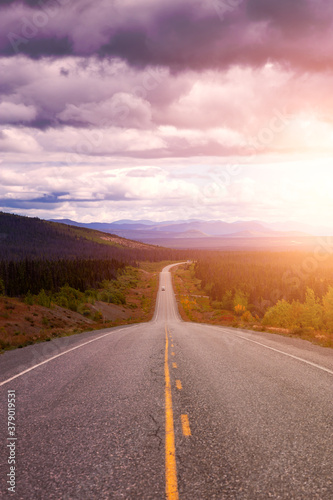 Scenic Route  Alaska Hwy  during a sunny and cloudy day. West of Whitehorse  Yukon  Canada. Sunset or Sunrise Sky