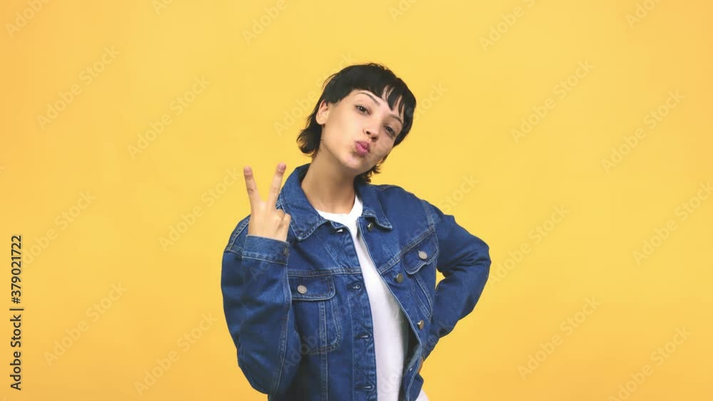 Young caucasian woman fun and happy, positive and natural, doing a gesture of victory, peace concept Young caucasian woman fun and happy, positive and natural, doing a gesture of victory, peace concept