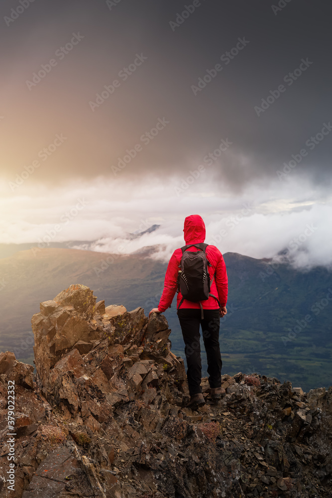 Adventurous Girl Hiking up a steep rocky mountain during a dark morning sunrise. Taken on a hike to Kings Throne Peak in Kluane National Park, Yukon, Canada. Adventurous Girl Hiking up a steep rocky mountain during a dark morning sunrise. Taken on a hike to Kings Throne Peak in Kluane National Park, Yukon, Canada.