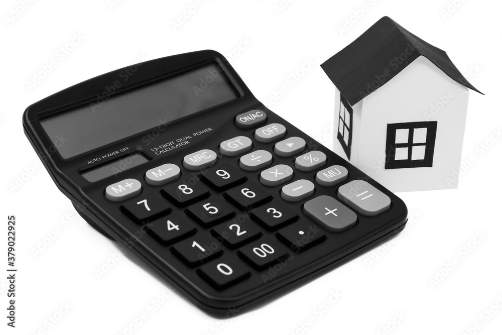 The toy house near the calculator isolated on white, mortgage calculator The toy house near the calculator isolated on white, mortgage calculator