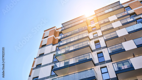 Architectural details of modern apartment building. Modern european residential apartment building complex. Sunset.