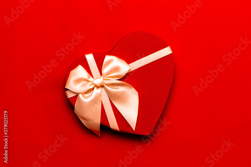Red heart shape gift box on red background