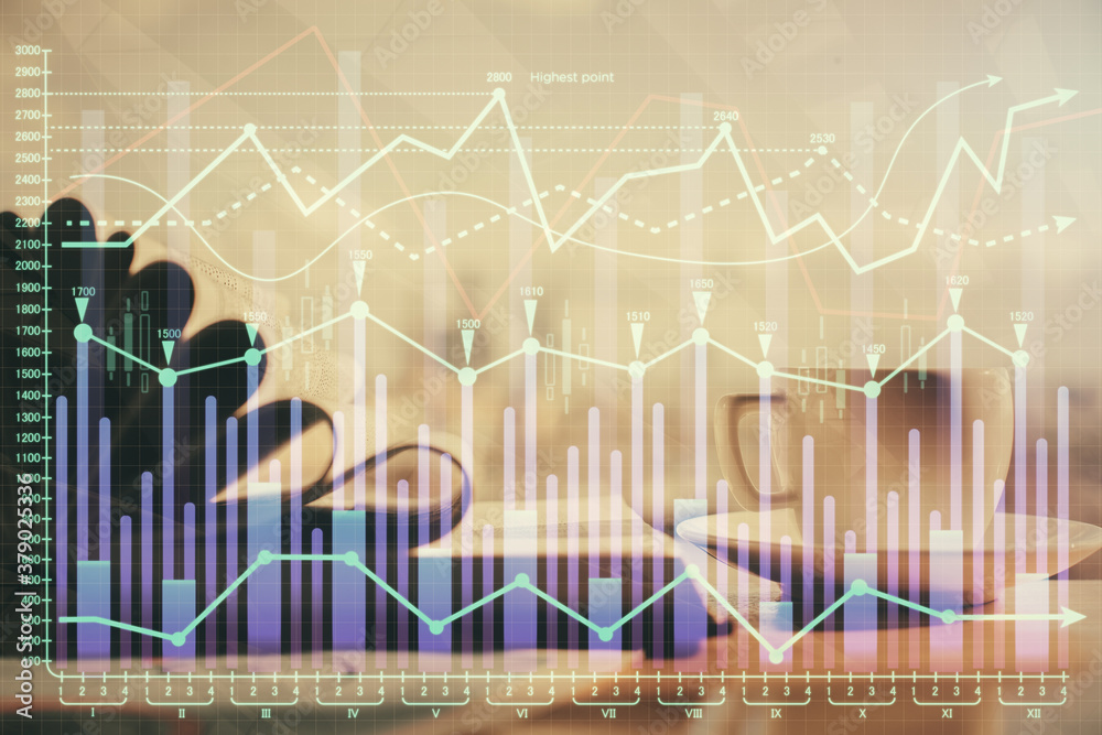 Double exposure of financial chart drawing and desktop with coffee and items on table background. Concept of forex market trading Double exposure of financial chart drawing and desktop with coffee and items on table background. Concept of forex market trading