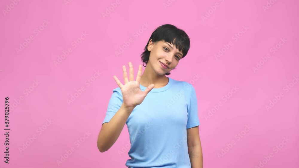 Young caucasian woman showing number five, symbol of counting, concept of mathematics, confident and cheerful Young caucasian woman showing number five, symbol of counting, concept of mathematics, confident and cheerful