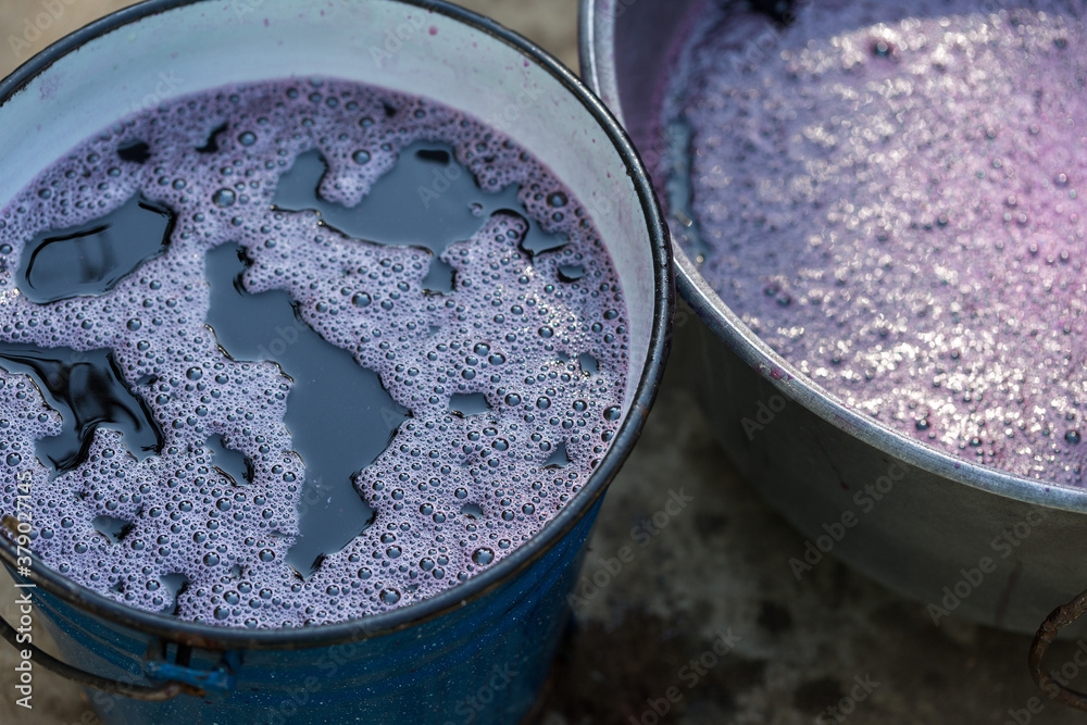 Grape juice close up during the autumn harvest. Traditional old technique of wine making. Filtering grape must. Grape juice close up during the autumn harvest. Traditional old technique of wine making. Filtering grape must.