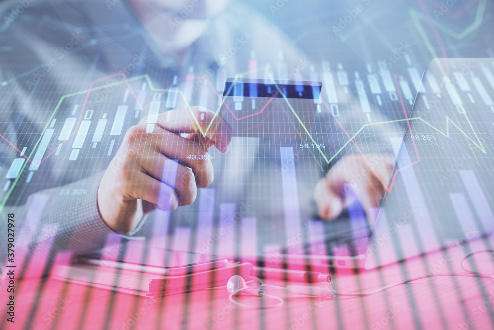 Double exposure of man hands holding a credit card and Forex graph drawing. Stock trading and digital fintech in Internet E-commerce concept.