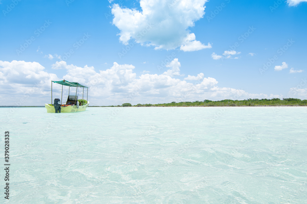 A little boat on transparent water in the Bacalar lagoon, Mexico