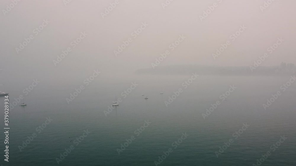 Aerial view of yachts anchored in the foggy and infinite ocean Aerial view of yachts anchored in the foggy and infinite ocean