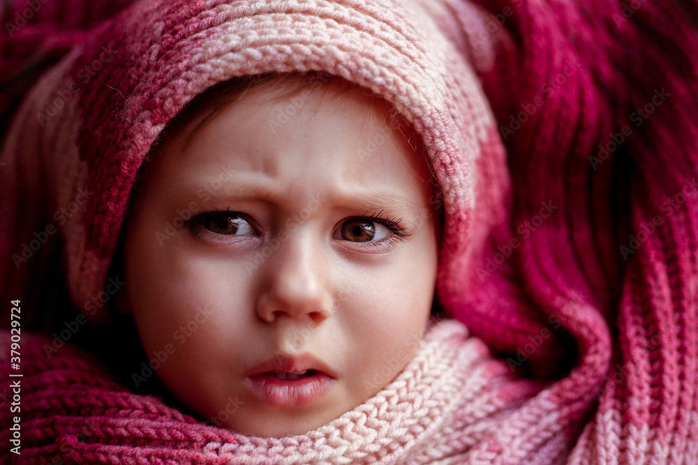 close-up portrait of a girl wrapped in a scarf. close-up portrait of a girl wrapped in a scarf.