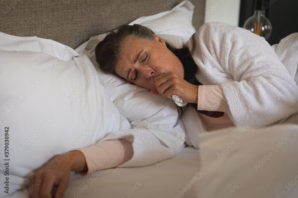 Woman coughing in the bed Woman coughing in the bed