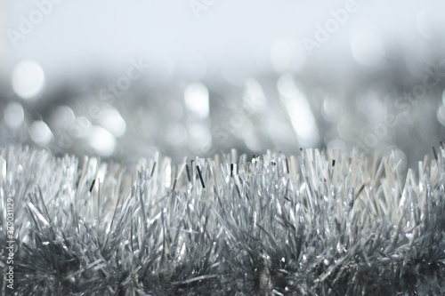 Silver tinsel background with soft focus, copy space, shiny Christmas card
