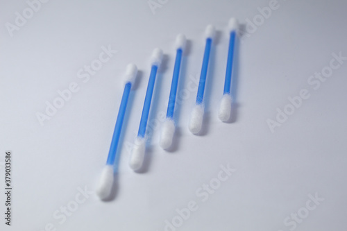 Cotton swab with white background and blue stem