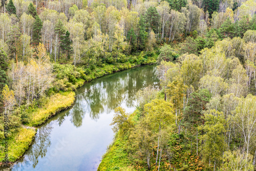Top view of the river in the Siberian taiga among the forests in autumn