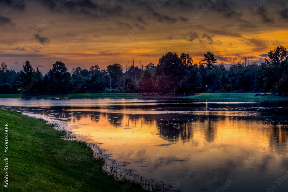 Sunrise over lake with reflections in the water on a fall day 