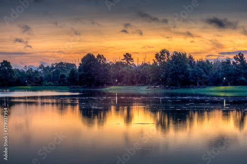 Sunrise over lake with reflections in the water on a fall day 