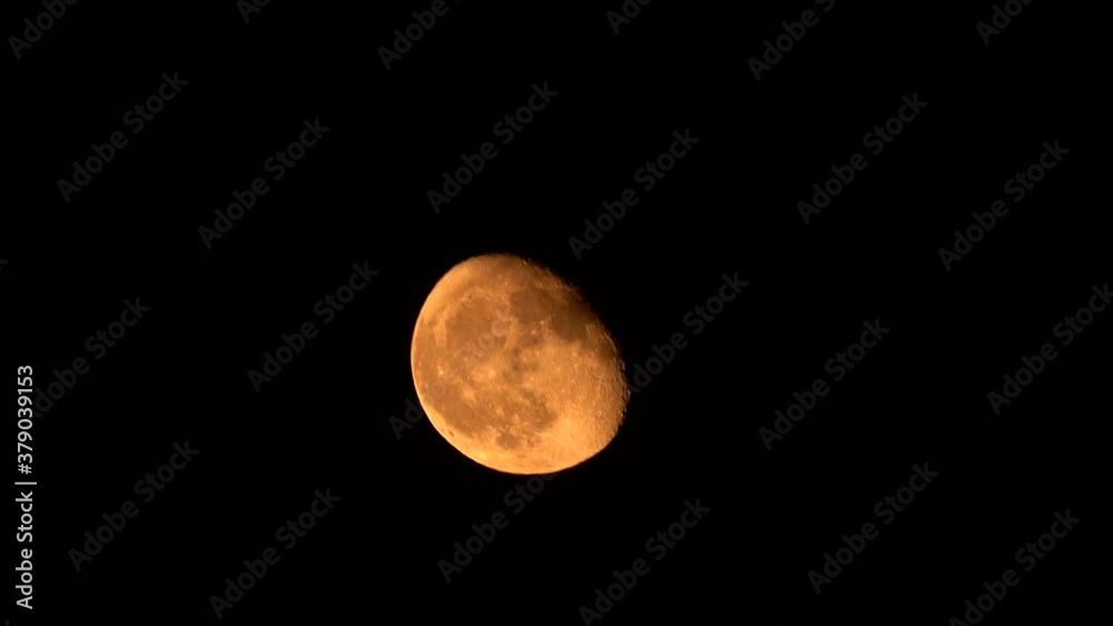 The rising moon is shown a pale orange color, due to a large California wildfire. The rising moon is shown a pale orange color, due to a large California wildfire.