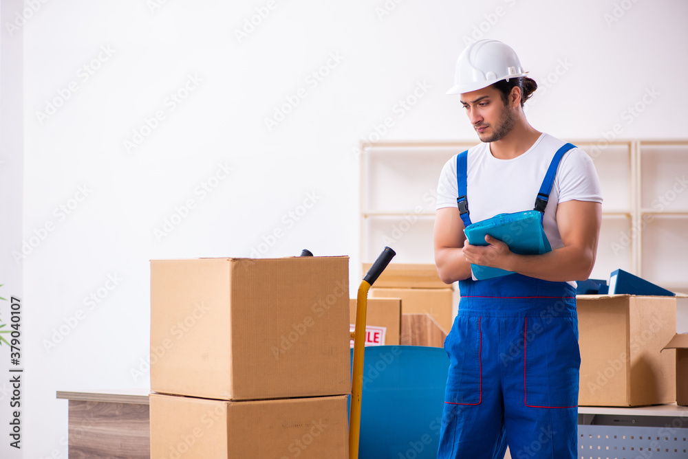 Young male professional mover doing home relocation Young male professional mover doing home relocation