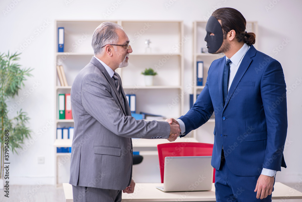 Two businessmen wearing masks during negotiations Two businessmen wearing masks during negotiations