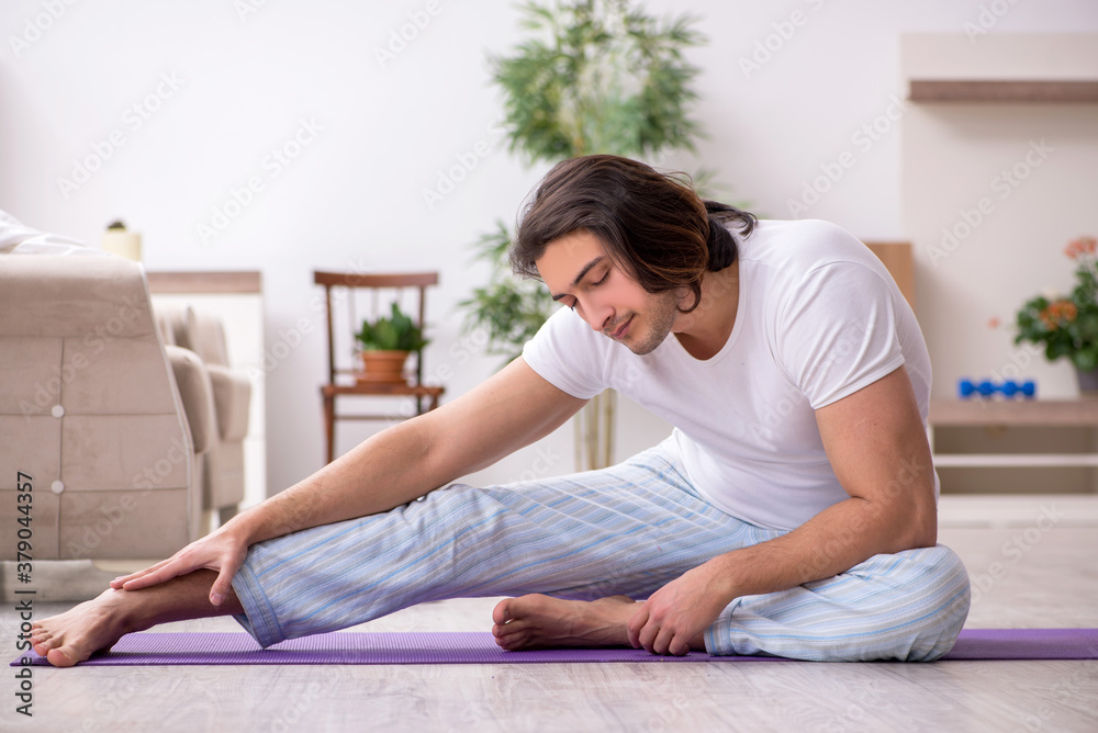 Young male starting day with morning exercises Young male starting day with morning exercises