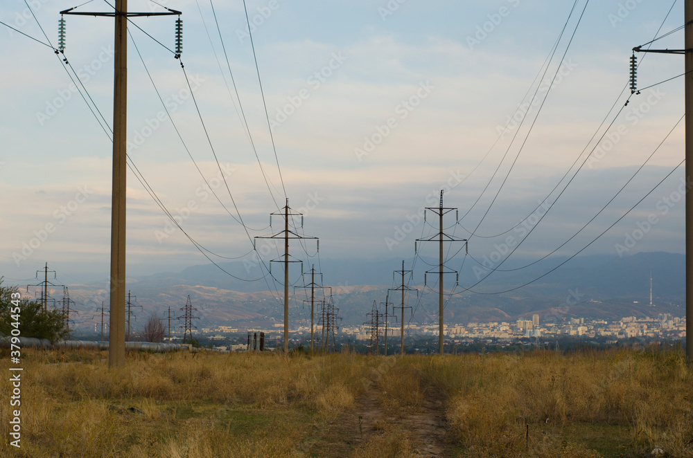Electric pylons with wires, Power lines branch off towards the city Electric pylons with wires, Power lines branch off towards the city