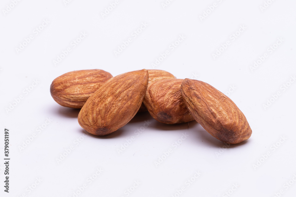 almonds on white background,Background of big raw peeled almonds situated arbitrarily almonds on white background,Background of big raw peeled almonds situated arbitrarily