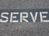 white serve letters on black asphalt or pavement