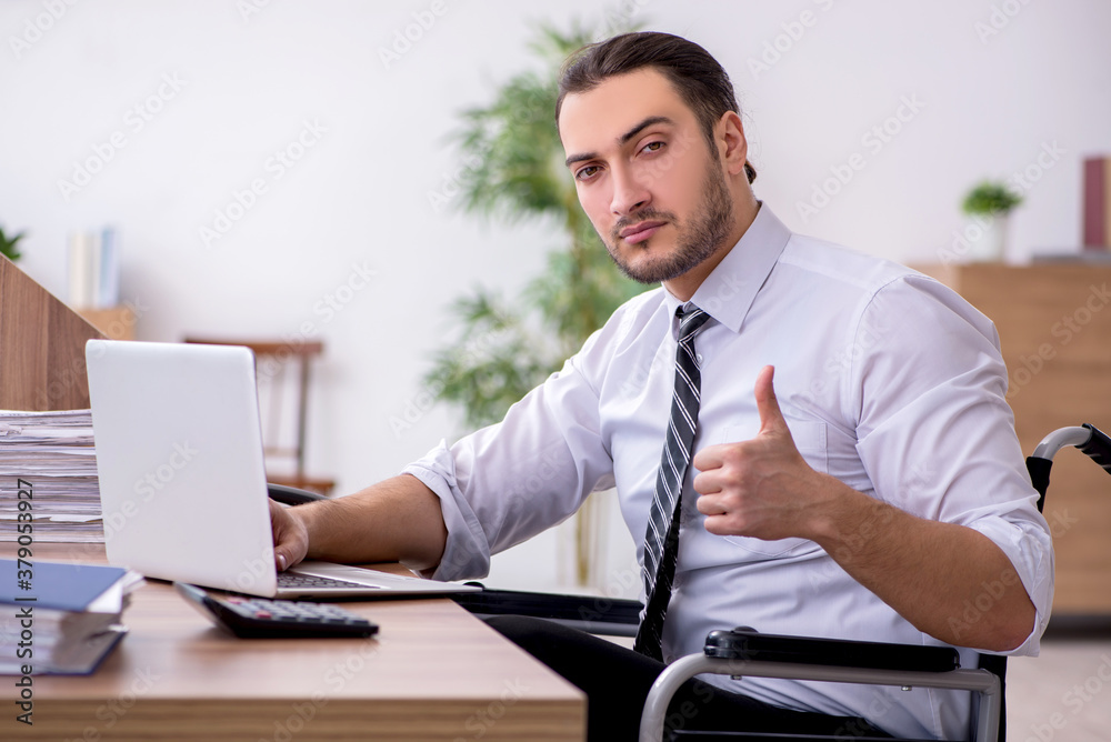 Young disabled employee suffering at workplace Young disabled employee suffering at workplace
