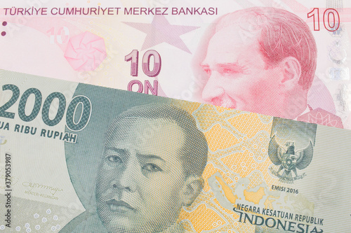 A macro image of a grey two thousand Indonesian rupiah bank note paired up with a red, ten lira bank note from Turkey.  Shot close up in macro. photo