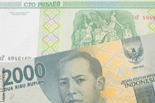 Wallpaper Mural A macro image of a grey two thousand Indonesian rupiah bank note paired up with a green one hundred ruble note from Belarus.  Shot close up in macro. Torontodigital.ca