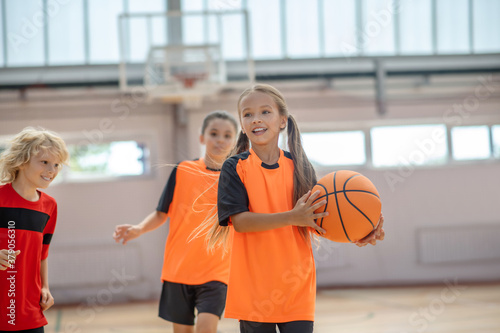 Kids in bright sportswear having basketball game © zinkevych