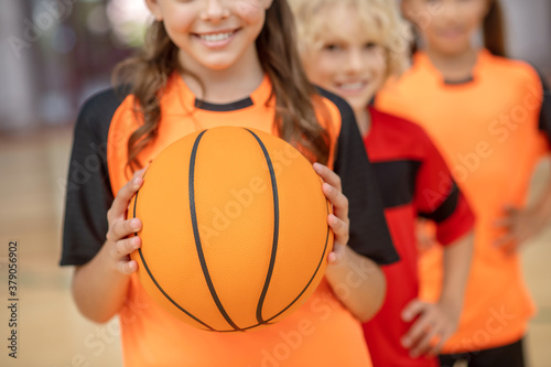 Close up picture of kids with a ball