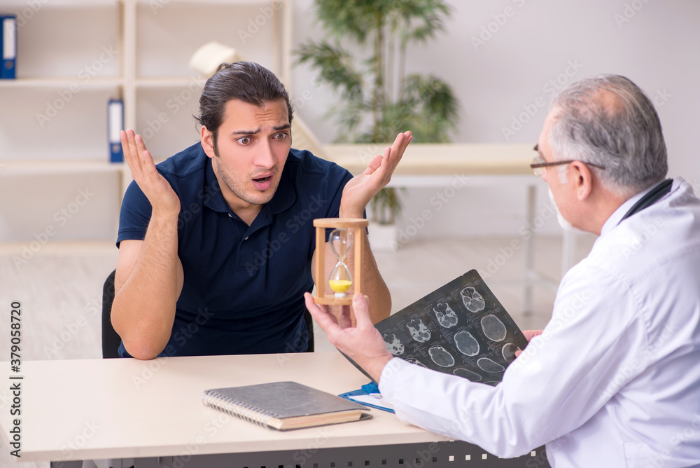 Fototapeta premium Male patient visiting doctor radiologist in time management conc