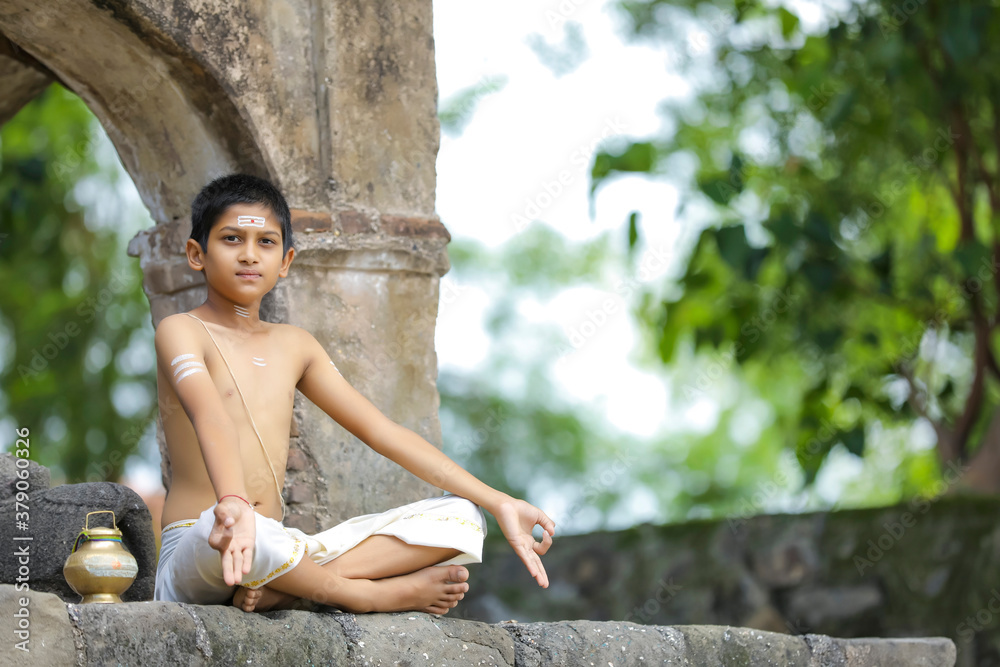 indian priest child doing yoga at park indian priest child doing yoga at park