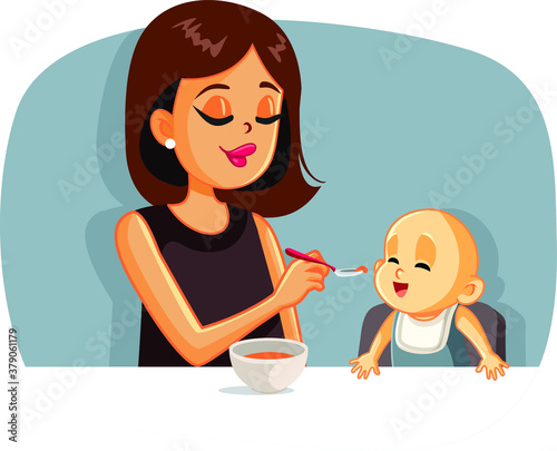 Happy Mother Feeding Her Baby Solid Food with a Spoon