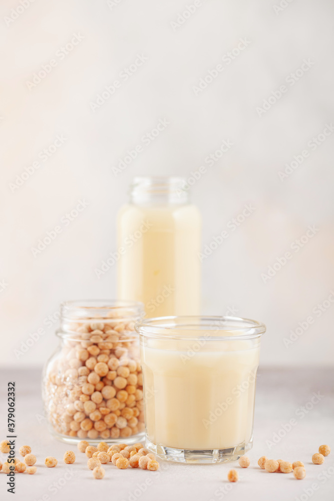 Vegetable pea milk in a bottle and peas in a jar. Gluten free, lactose free product Vegetable pea milk in a bottle and peas in a jar. Gluten free, lactose free product
