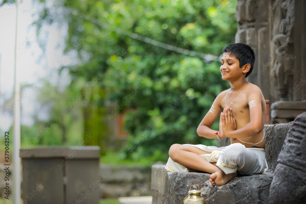 indian priest child doing yoga at park indian priest child doing yoga at park