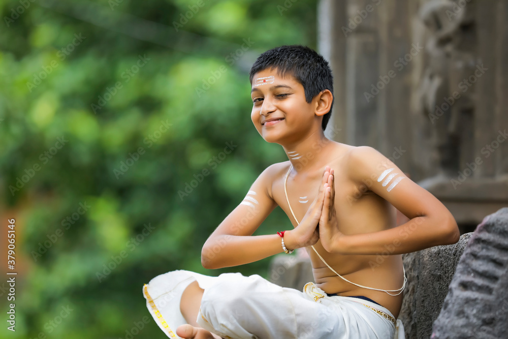 A indian priest child with holy water pot A indian priest child with holy water pot