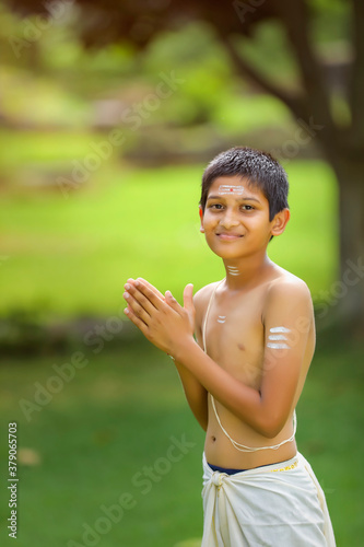 A indian priest child with holy water pot