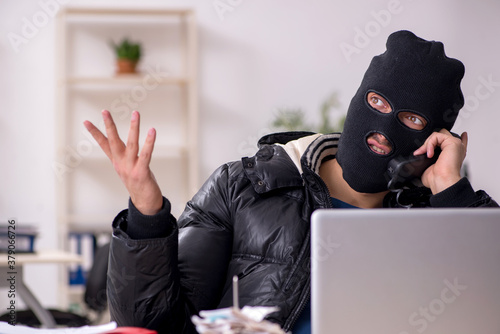 Fényképezés Young male burglar in the office