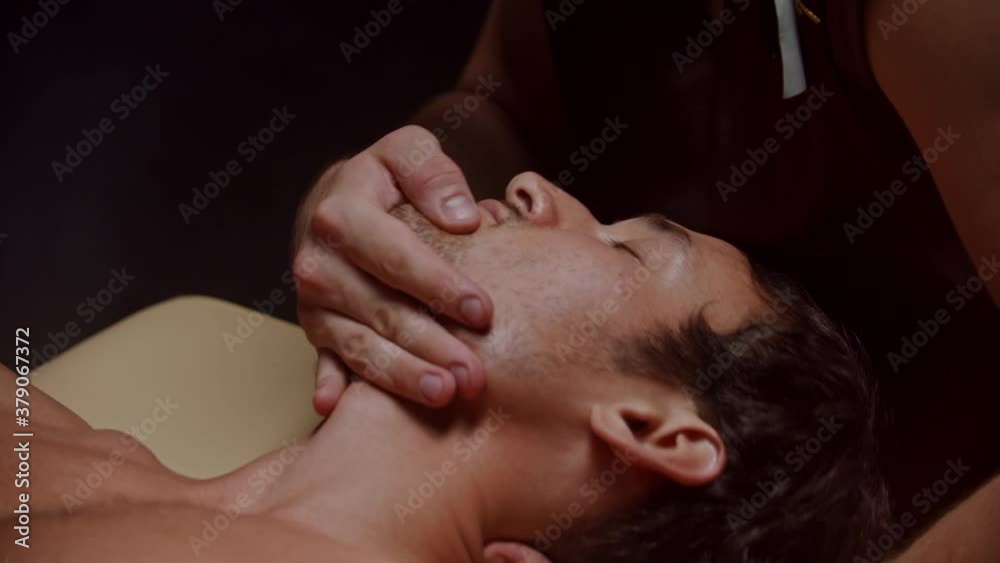 Chiropractic session - the client is lying on his back and the therapist sets his vertebrae Chiropractic session - the client is lying on his back and the therapist sets his vertebrae