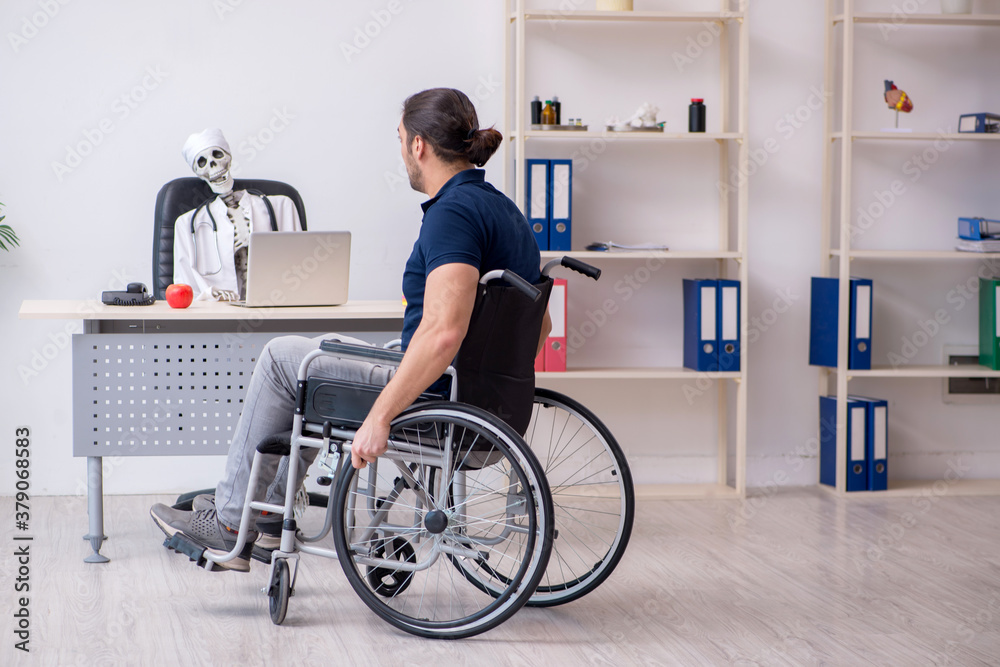 Young man in wheel-chair visiting dead doctor Young man in wheel-chair visiting dead doctor