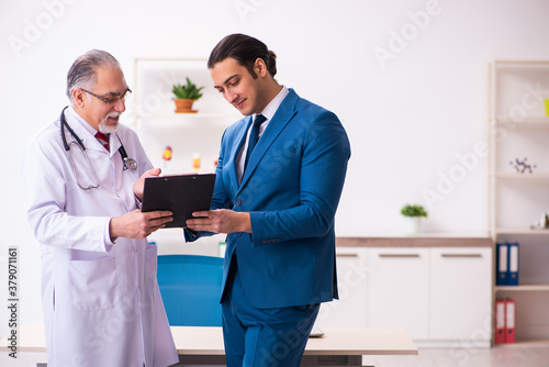 Young businessman meeting with old doctor