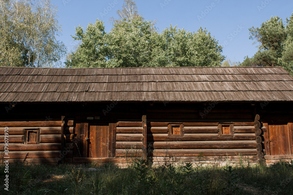 old wooden house with wooden roof in the village