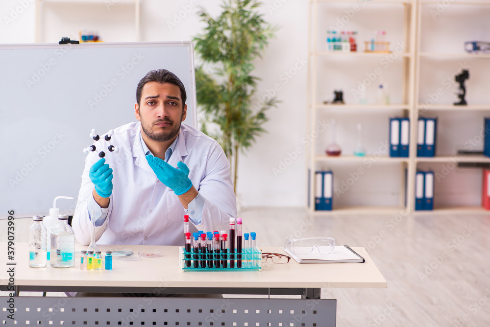 Young male chemist working in the lab Young male chemist working in the lab