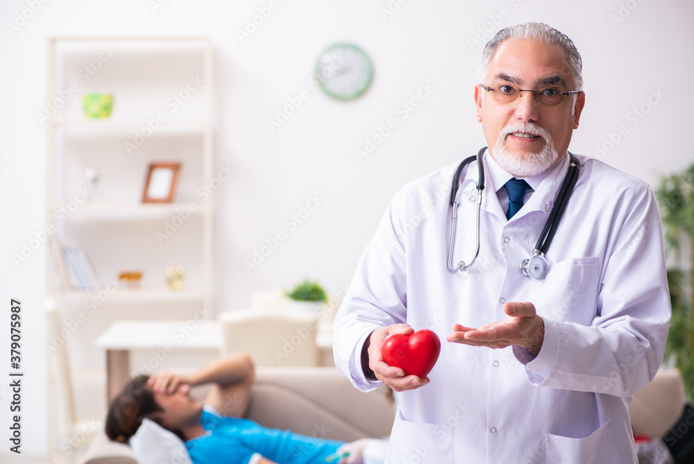 Two doctors visiting sick young man at home Two doctors visiting sick young man at home