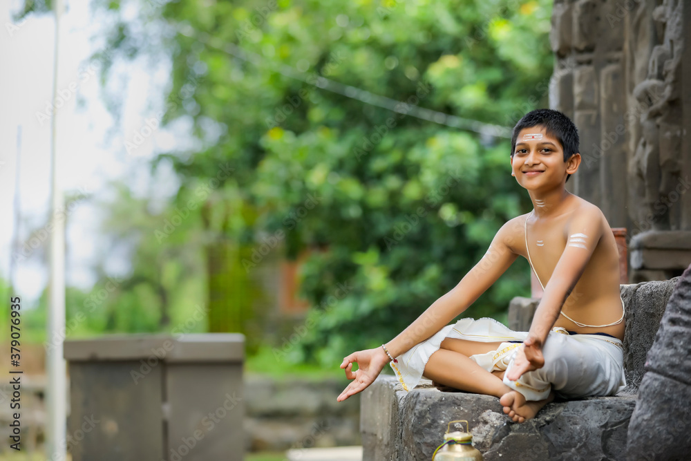 the indian priest child doing meditation the indian priest child doing meditation