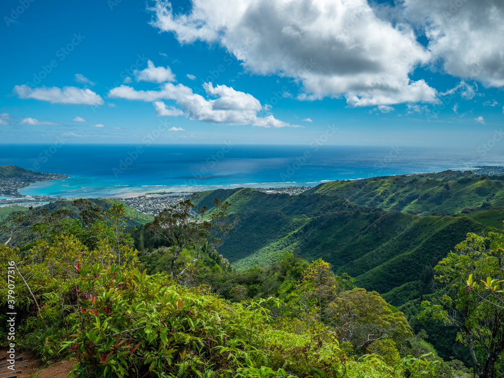 The view overlooking the town.  Blue sky over green mountains. Amazing view of the ocean. 
 Kuliouou Ridge Trail, Hawaii, Oahu