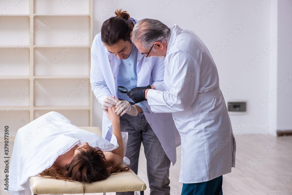 Police coroner examining dead body corpse in morgue Police coroner examining dead body corpse in morgue